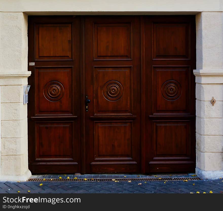 Red wooden gate in stone frame