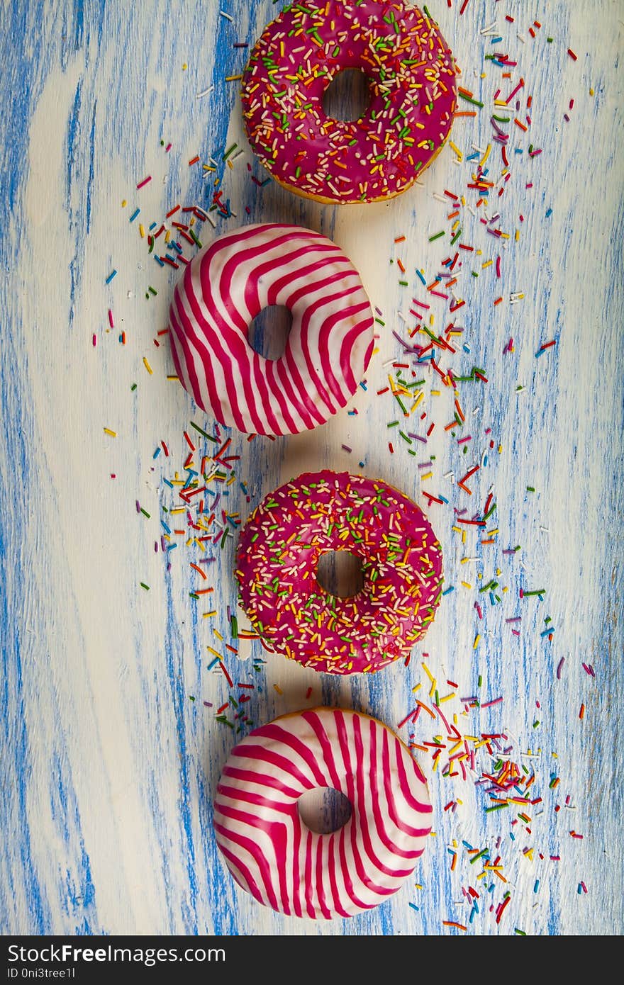 Donuts On A Blue Wooden Background