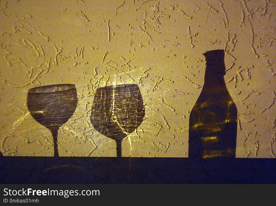 Wine bottle and two glasses shadow