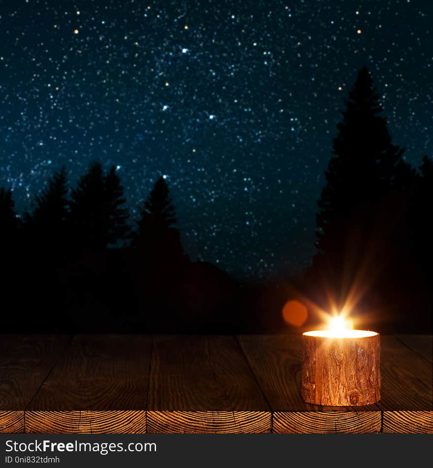 A Burning Candle On The Table