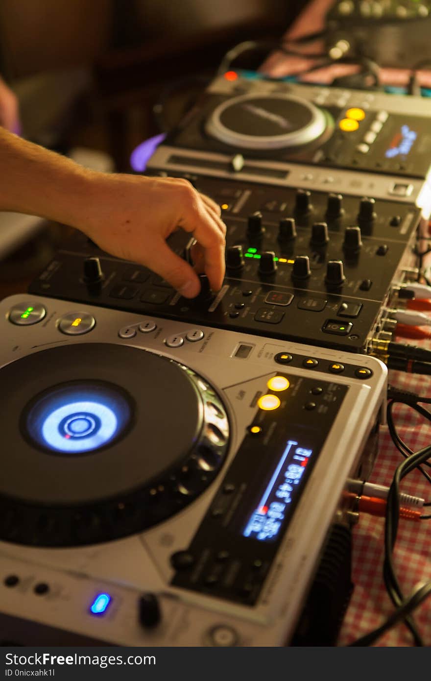 Dj mixing music on professional mixer in club. Dj mixing music on professional mixer in club