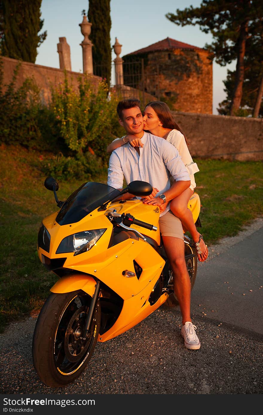 Young couple on a motor bike on a late summer afternoon