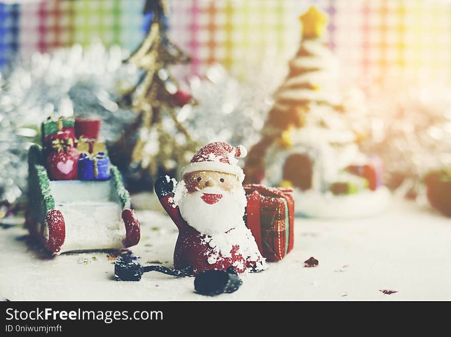 Santa Claus, snowman, houses & snow Sledge miniature model studio shot on colorful background for family, giving, season, Christmas, holiday, new year, travel and gathering concept