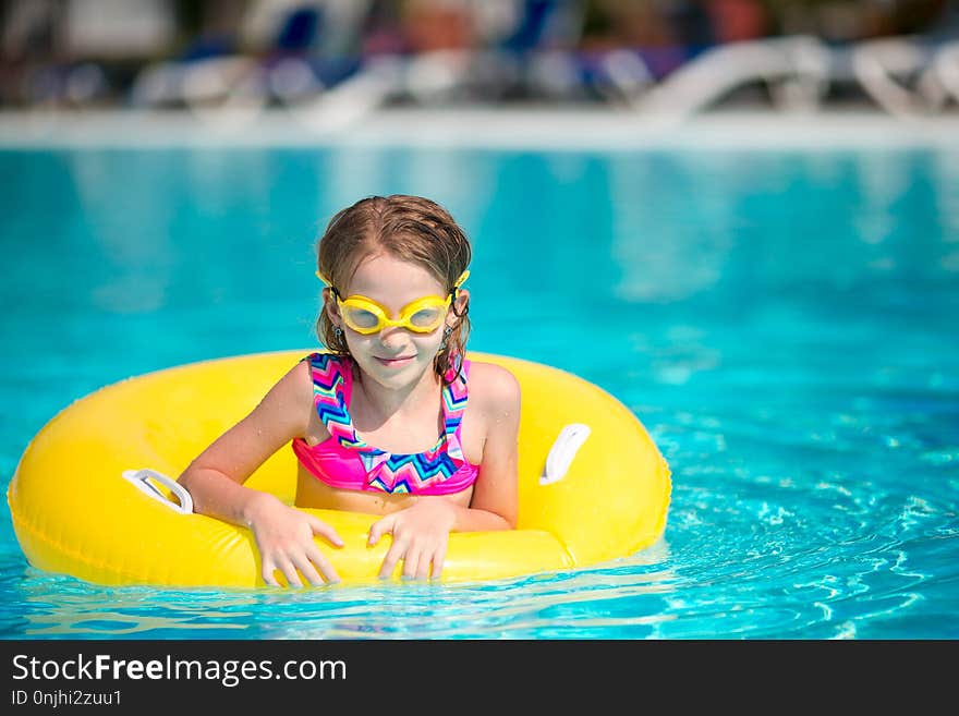 Little happy adorable girl in outdoor swimming pool. Little happy adorable girl in outdoor swimming pool