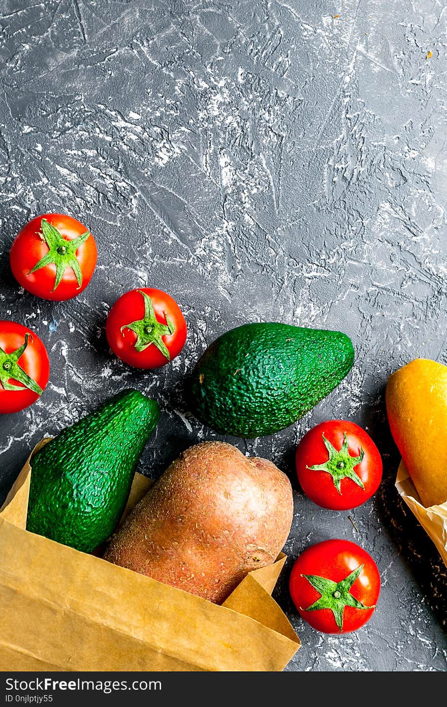 Store concept with vegetables and paper bag on gray table background top view mockup. Store concept with vegetables and paper bag on gray table background top view mockup