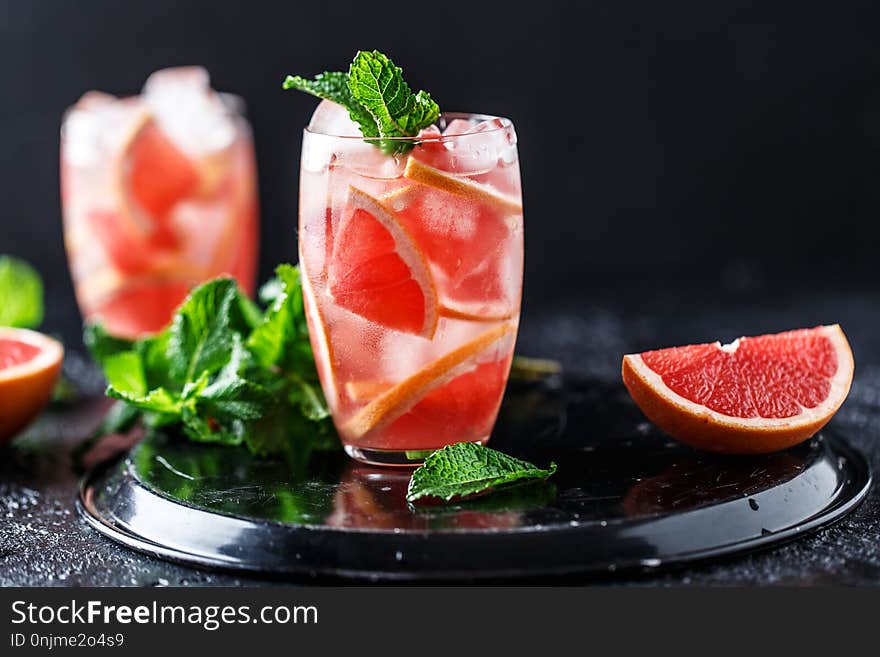 Fresh grapefruit cocktail. Fresh summer cocktail with grapefruit and ice cubes. Glass of grapefruit mojito.