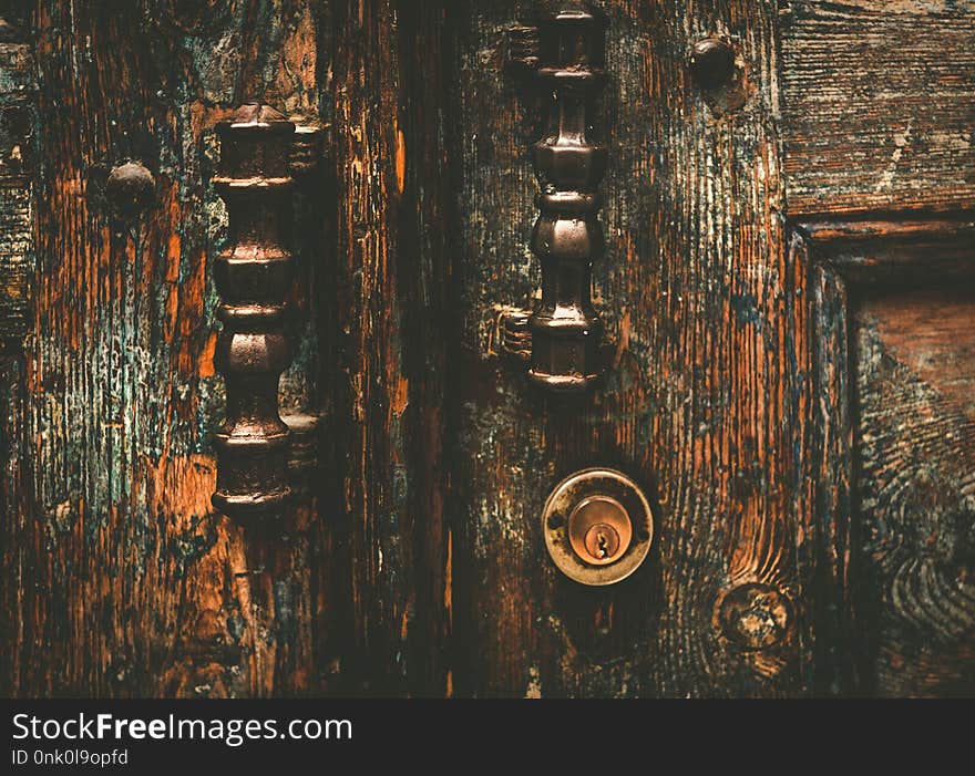 Architectural detail of a vintage, rustic door handle ,vintage antique door handle on the old wooden door. Metal handle and lock