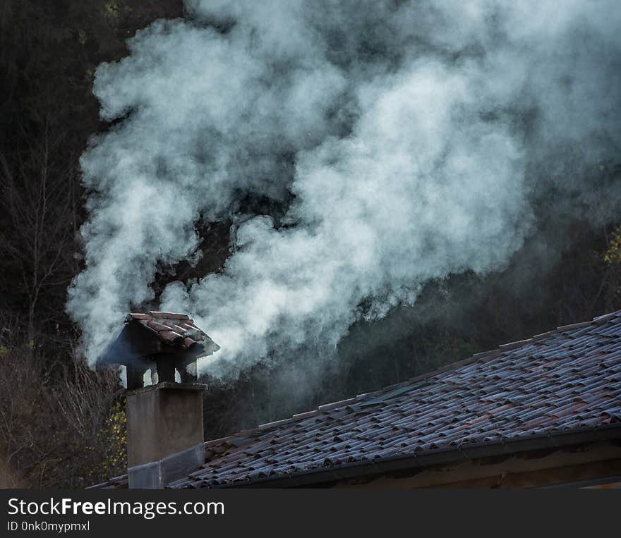 Smoke coming out of an old chimney