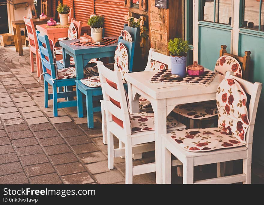 Retro, vintage view of Pastel coffee shop with wooden tables and chairs in Balat, old town of Istanbul, Turkey. Outdoor cafe. Photo in vintage image style.ISTANBUL, TURKEY