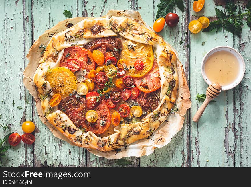 Tomatoes Tart with Fresh Tomatoes and Cheese on wooden background