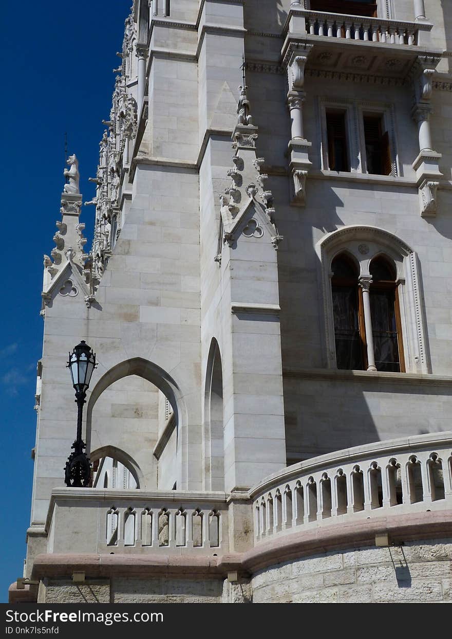 Detail of the Hungarian Parliament building in Budapest under blue sky with finely carved decorative sand stone elements