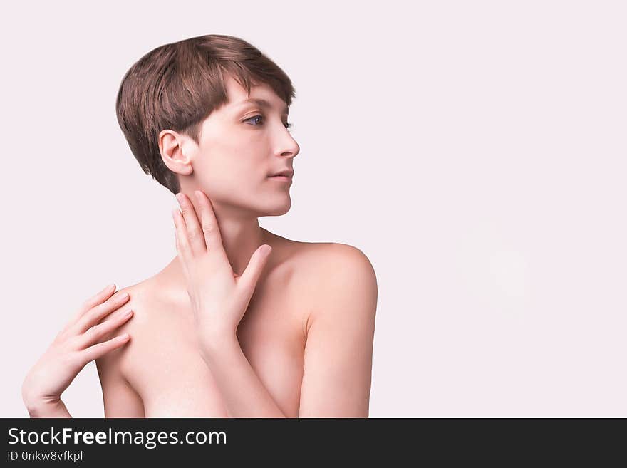 Beautiful woman. Female face close up. Portrait of young caucasian woman at studio isolated on white. Fresh skin and beauty concept. Short haircut, long neck, perfect skin. Beautiful woman. Female face close up. Portrait of young caucasian woman at studio isolated on white. Fresh skin and beauty concept. Short haircut, long neck, perfect skin