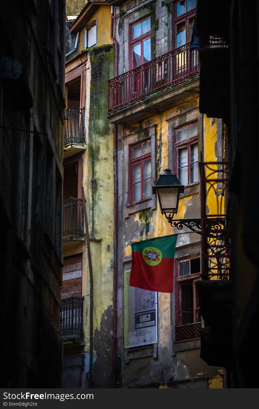 Portugal flag on the street of porto with colorfull house in the background