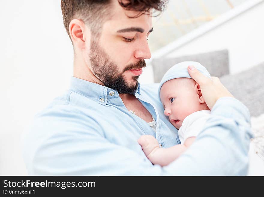 Loving father with baby in his arms