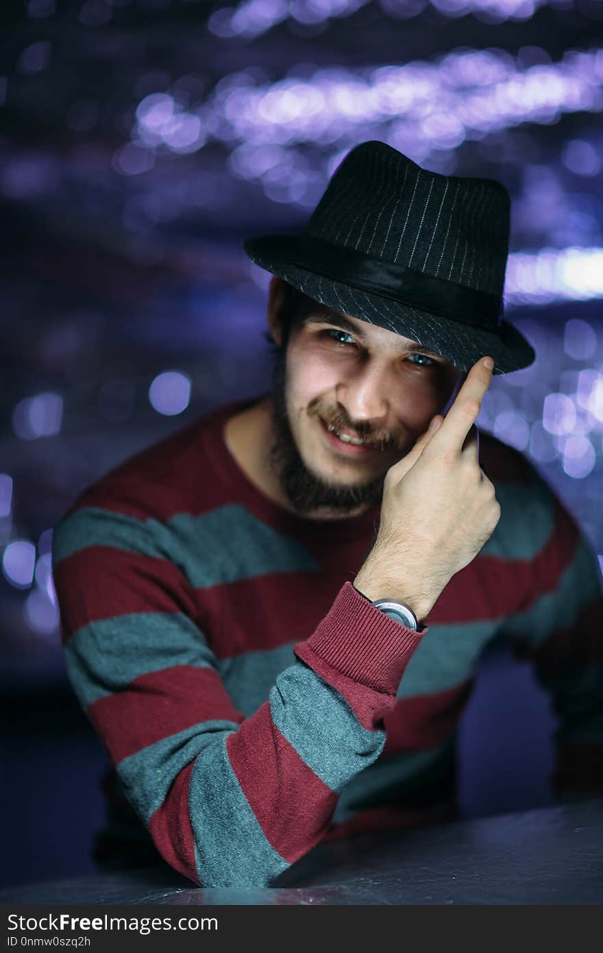 Portrait of a guy in a hat on a blurred background