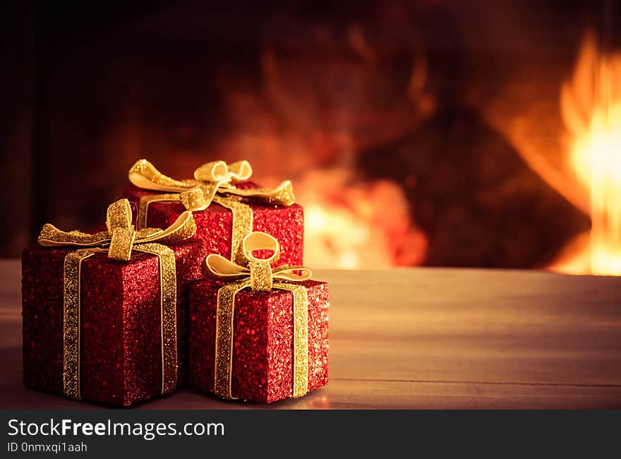 Christmas decoration on wooden table with blurred fireplace in the background. Christmas decoration on wooden table with blurred fireplace in the background.