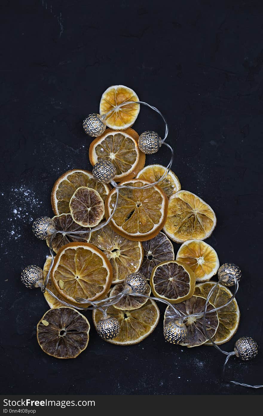 Christmas tree of orange slices. Christmas tree made of orange and lemon slices. Christmas tree made of dried oranges on dark background