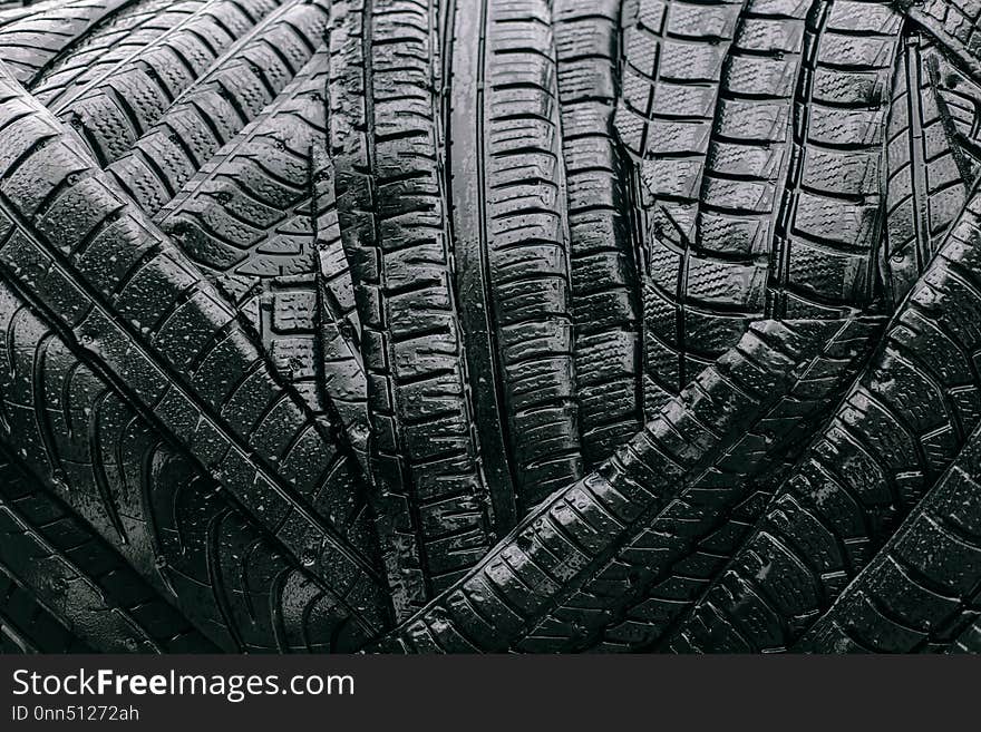 Texture of black and wet automobile tires. Art object, background, isolate. Texture of black and wet automobile tires. Art object, background, isolate