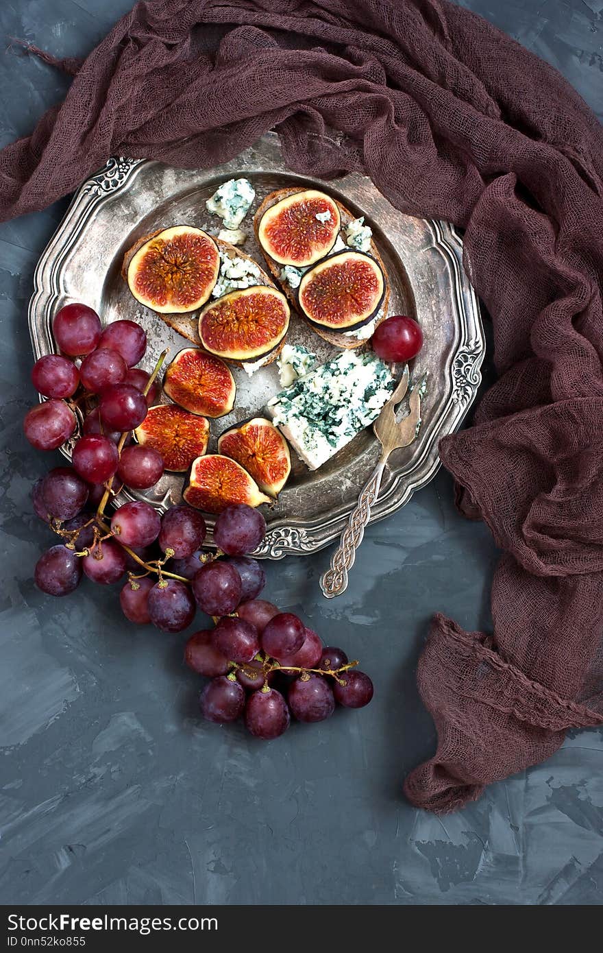 Breakfast with toasts with figs, jam and grape on dark backgroundn. Breakfast with toasts with figs, jam and grape on dark backgroundn