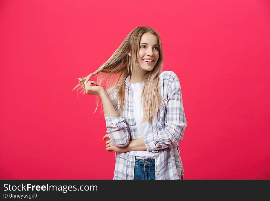 Smiling beautiful woman portrait with crossed arms on pink background