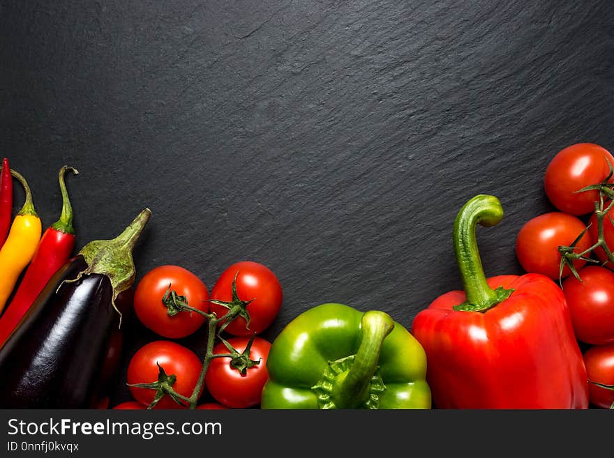 Colorful vegetables for healthy diet on black background with copy space