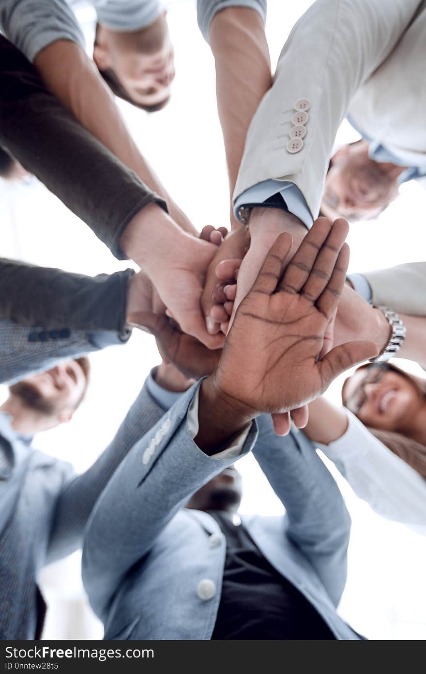 Business background.business team making a stack of hands. the concept of unity