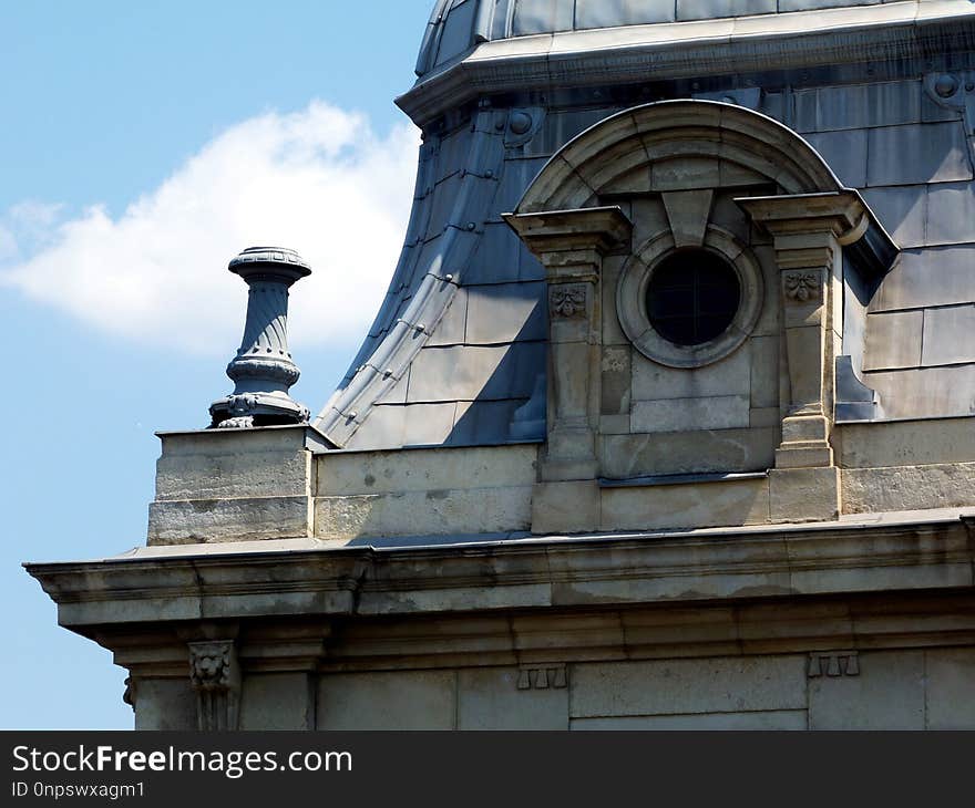 Zink plate covered antique roof detail in downtown Budapest with ornaments under blue sky. Zink plate covered antique roof detail in downtown Budapest with ornaments under blue sky