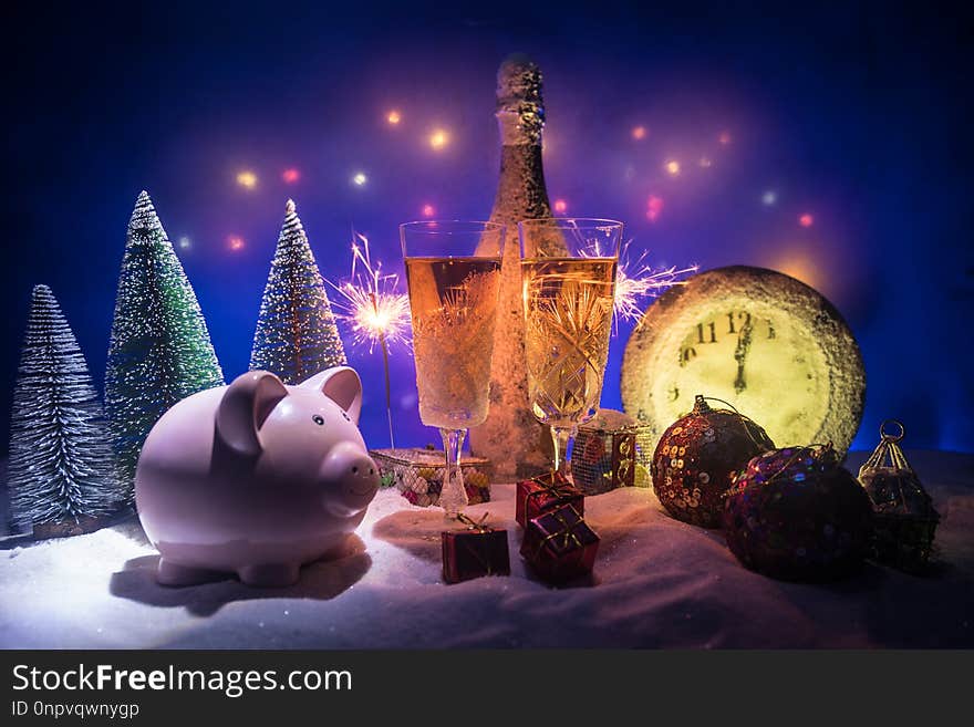 Two glasses of champagne with Christmas decoration. Traditional winter holiday alcohol drink in snow with creative New Year artwork. Copy space. Selective focus