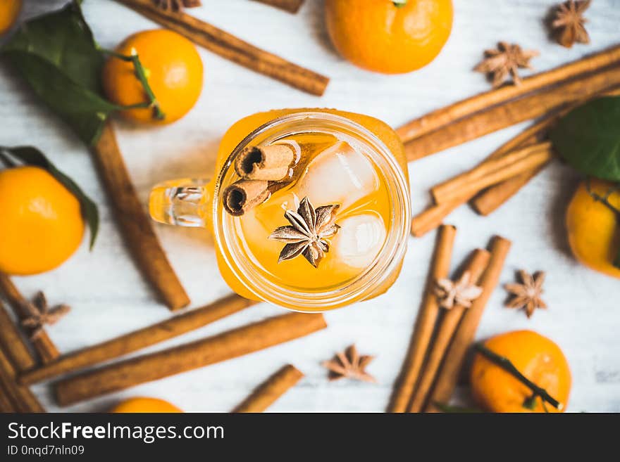 Icy cold mandarin beverage on the rustic background. Selective focus. Shallow depth of field.