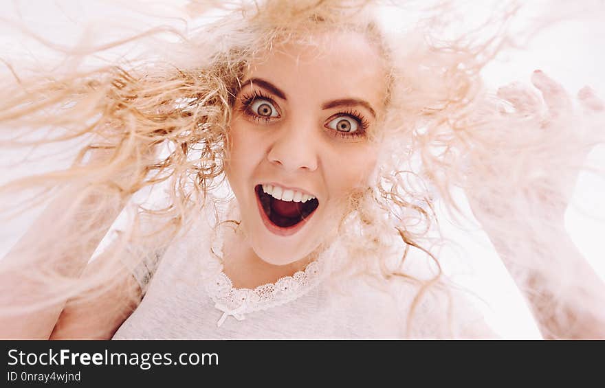 Crazy funny woman looking from bottomg at camera. Female having long blonde hair. Haircare concept. Crazy funny woman looking from bottomg at camera. Female having long blonde hair. Haircare concept