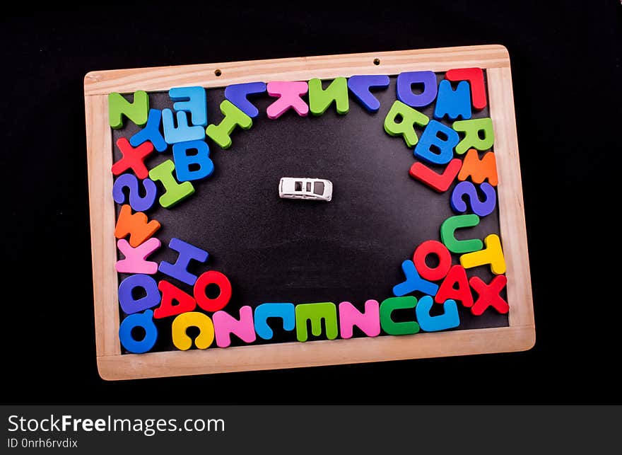 Car and Colorful Letters of Alphabet made of wood. Car and Colorful Letters of Alphabet made of wood