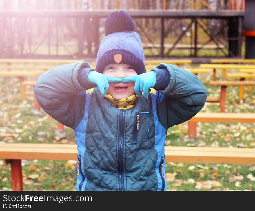 Cheerful Boy Grimaces, Autumn In The Park