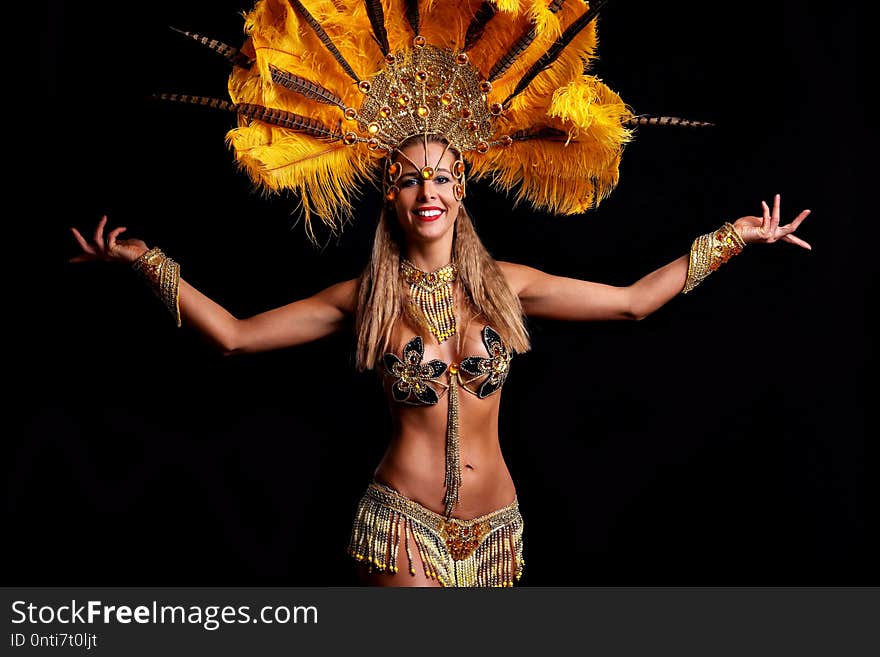 Brazilian woman posing in samba costume over black background