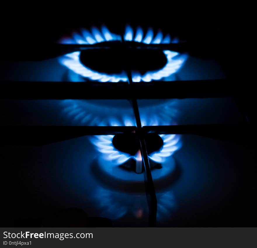 Gas burner with burning blue flame in the dark room. Gas burner with burning blue flame in the dark room