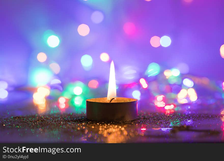 Magic Christmas candle and glittering holiday lights. Magic Christmas candle and glittering holiday lights