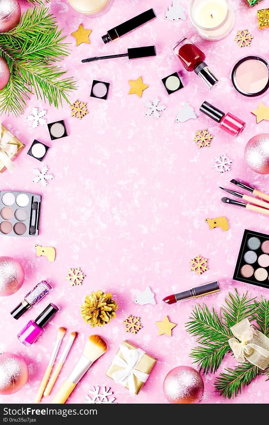Make up cosmetics and Christmas decorations on artistic pink background, copy space, top view. Make up cosmetics and Christmas decorations on artistic pink background, copy space, top view