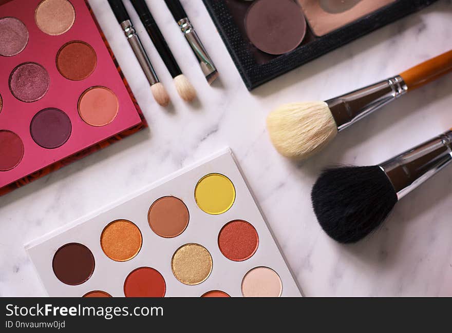 Make-up brushes. make-up artist workplace. trendy eye shadow colors. colorful palettes. basic make-up colors. top view. Make-up brushes. make-up artist workplace. trendy eye shadow colors. colorful palettes. basic make-up colors. top view