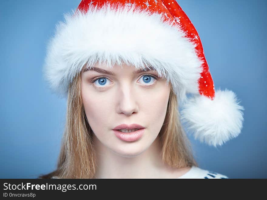 Closeup Of A Woman Wearing Santa Hat, Looking At Camera