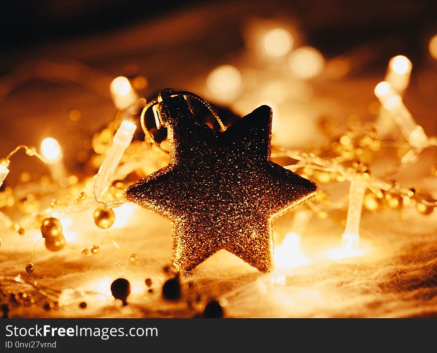 Christmas and New Year decorations star on yellow lights background