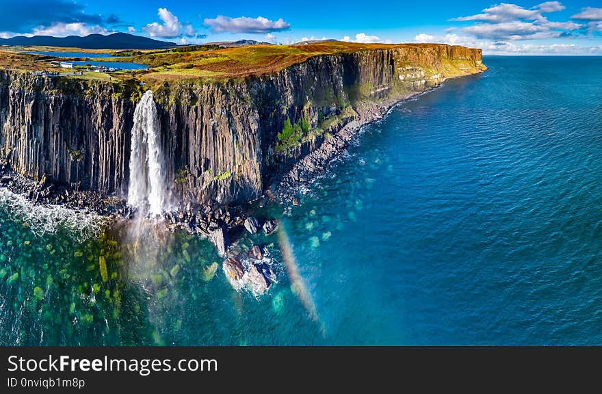 Aerial view of the dramatic coastline at the cliffs by Staffin with the famous Kilt Rock waterfall - Isle of Skye - Scotland.