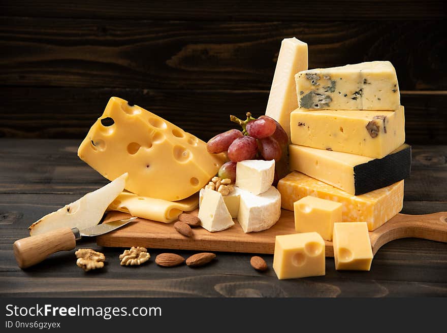 Various types of cheese on a rustic table