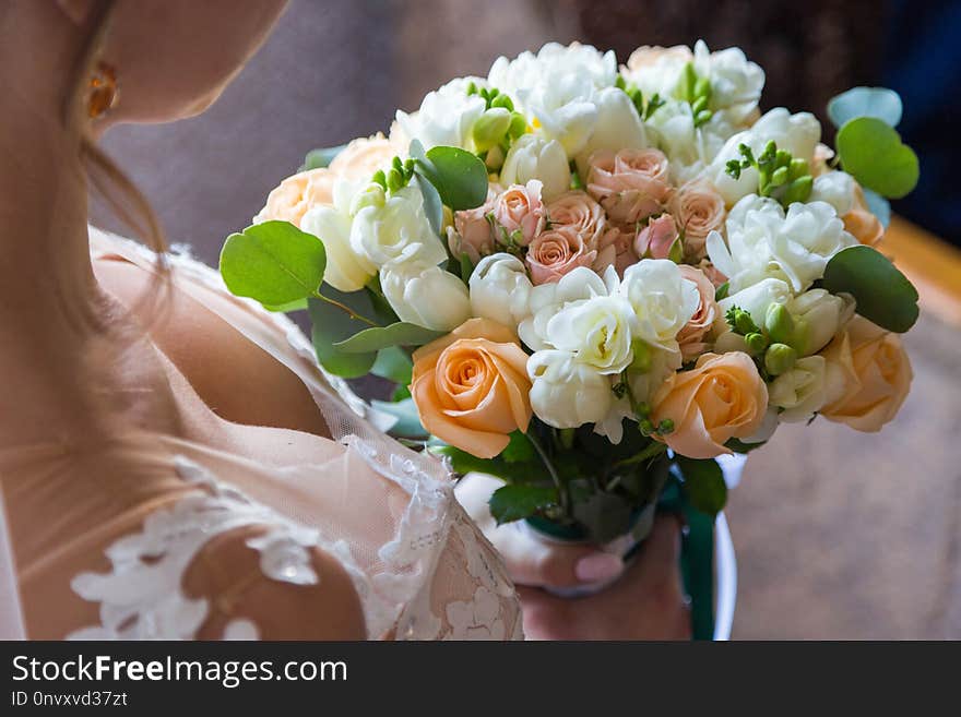 Wedding bouquet bride behind. holds beautiful her back