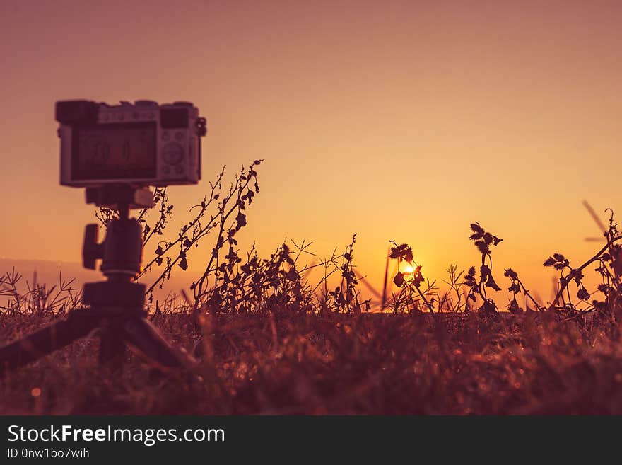 Professional camera on tripod taking picture film video of sunrise over sea surface, Greece. Professional camera on tripod taking picture film video of sunrise over sea surface, Greece