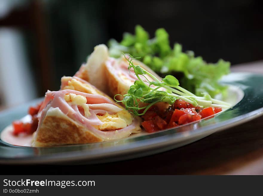 Breakfast burrito ham and eggs with salad vintage style on a dish