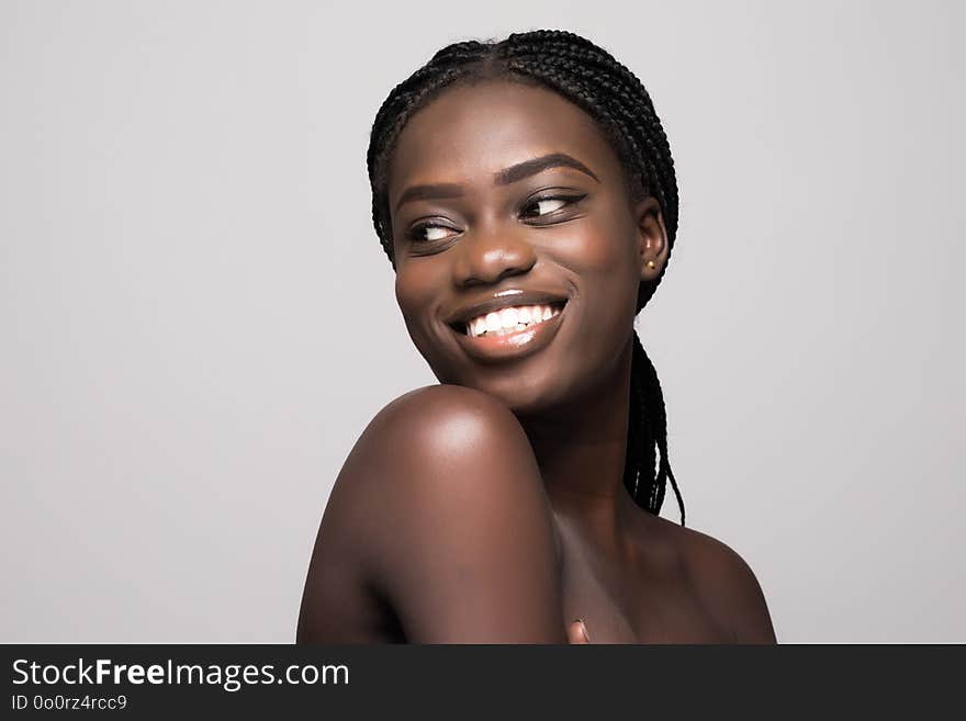 Portrait Of Beautiful African Woman With Dark Hair, Fresh Glowing Skin Face And Bare Shoulders Isolated On White