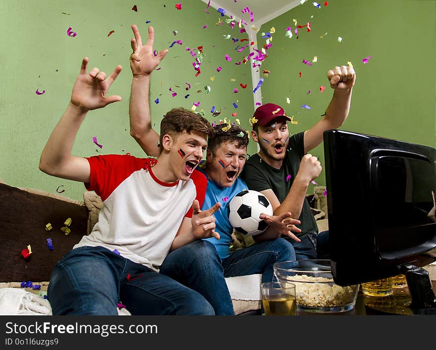 Cheerful family watching soccer cup on television