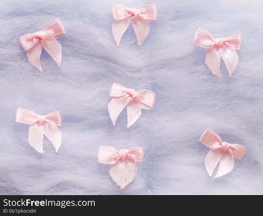 Pink small cute bow on violet background. pink ribbon