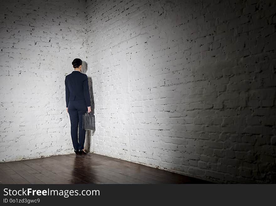 Full length rear view of businesswoman standing in corner at office