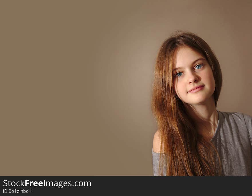 Blue eyed brown haired shy girl with flowing hair