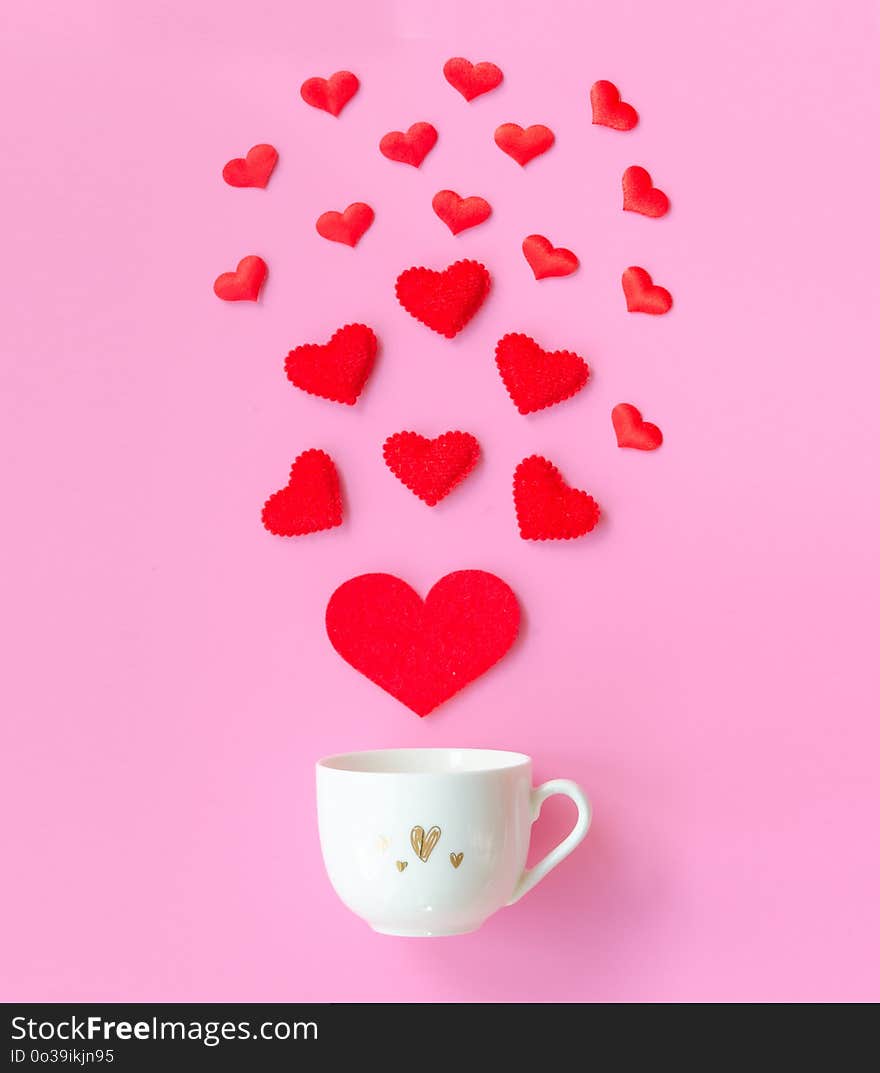 Valentine`s Day with red hearts, cup coffee on pink background, copy space Valentines day Concept. Flat lay